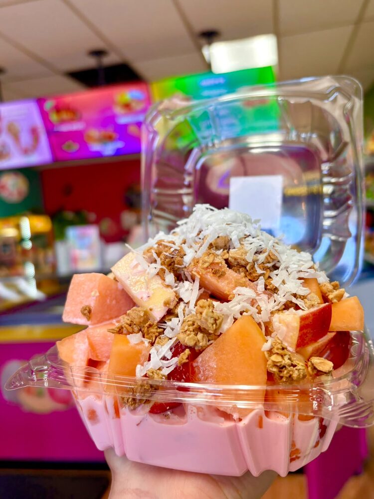 Fruit bowl with cantaloupe, strawberries, granola and coconut