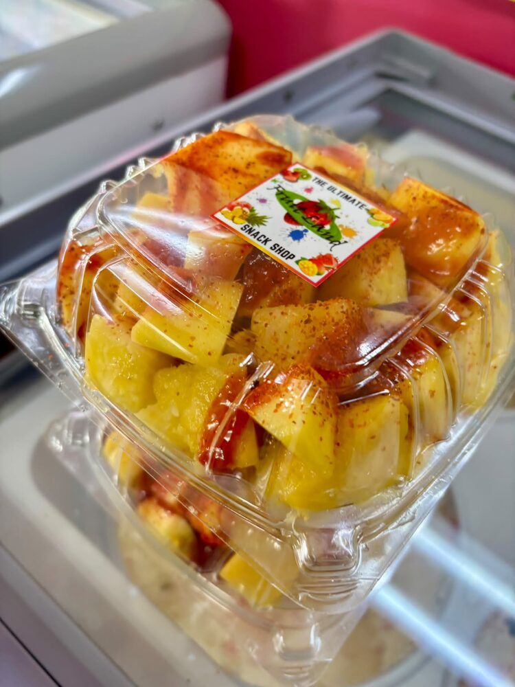 Pineapple and apple fruit bowl dressed with chamoy and chili