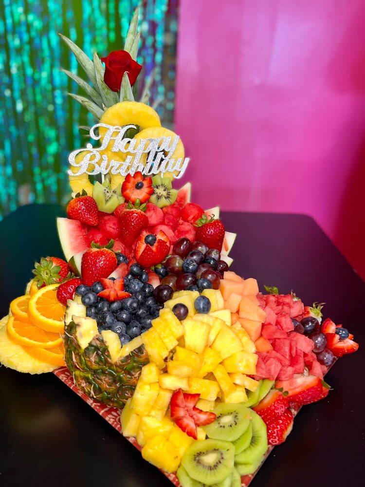 Birthday fruit tray with pineapple, strawberries, kiwi and grapes